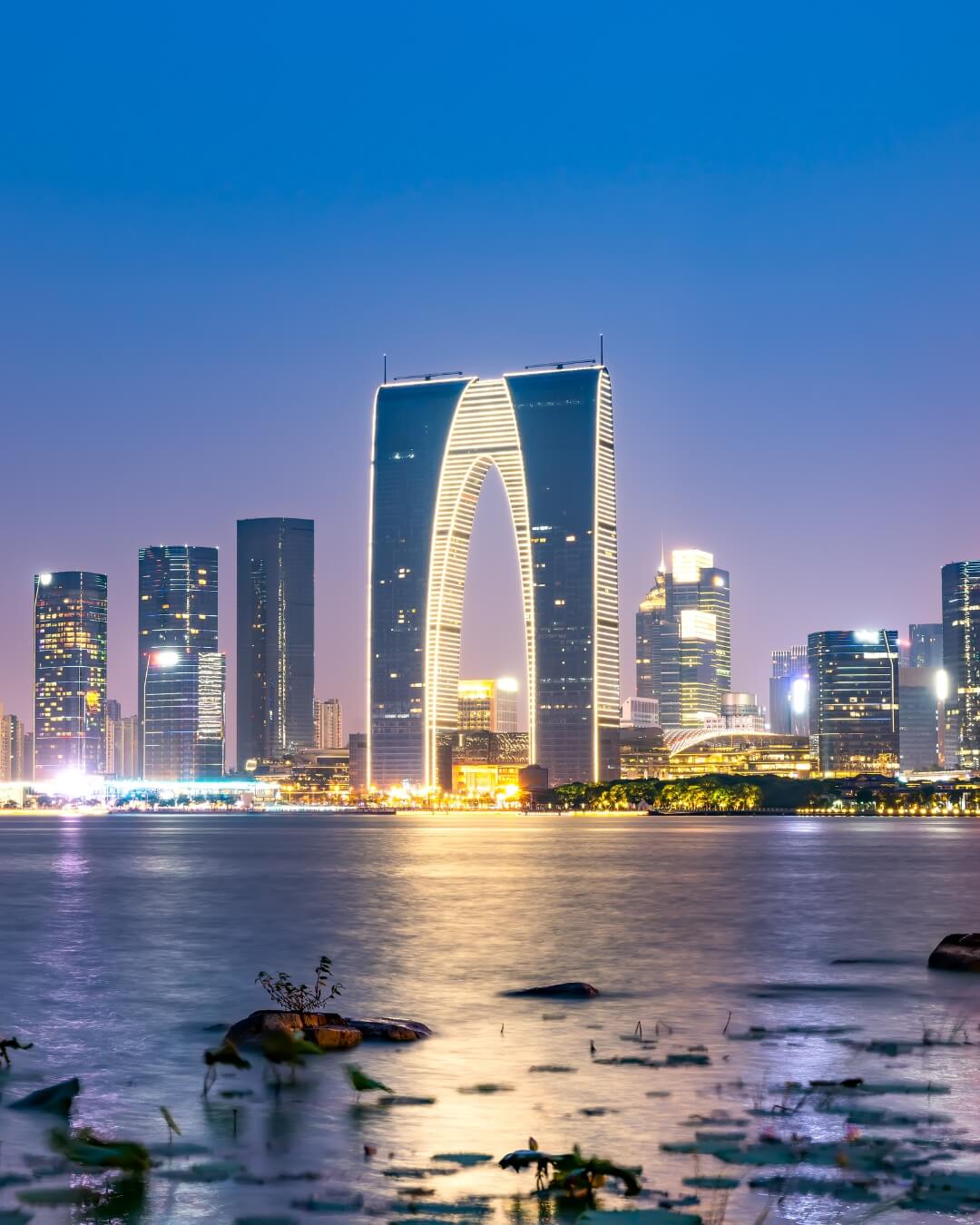 Asian city skyline at night with lights and towers